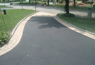 paved asphalt driveway with concrete pavers